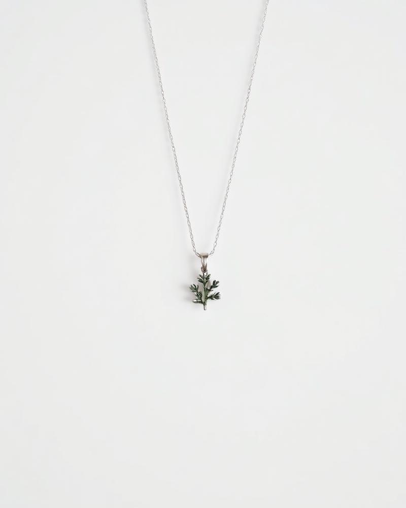 Silver necklace with a juniper branch pendant